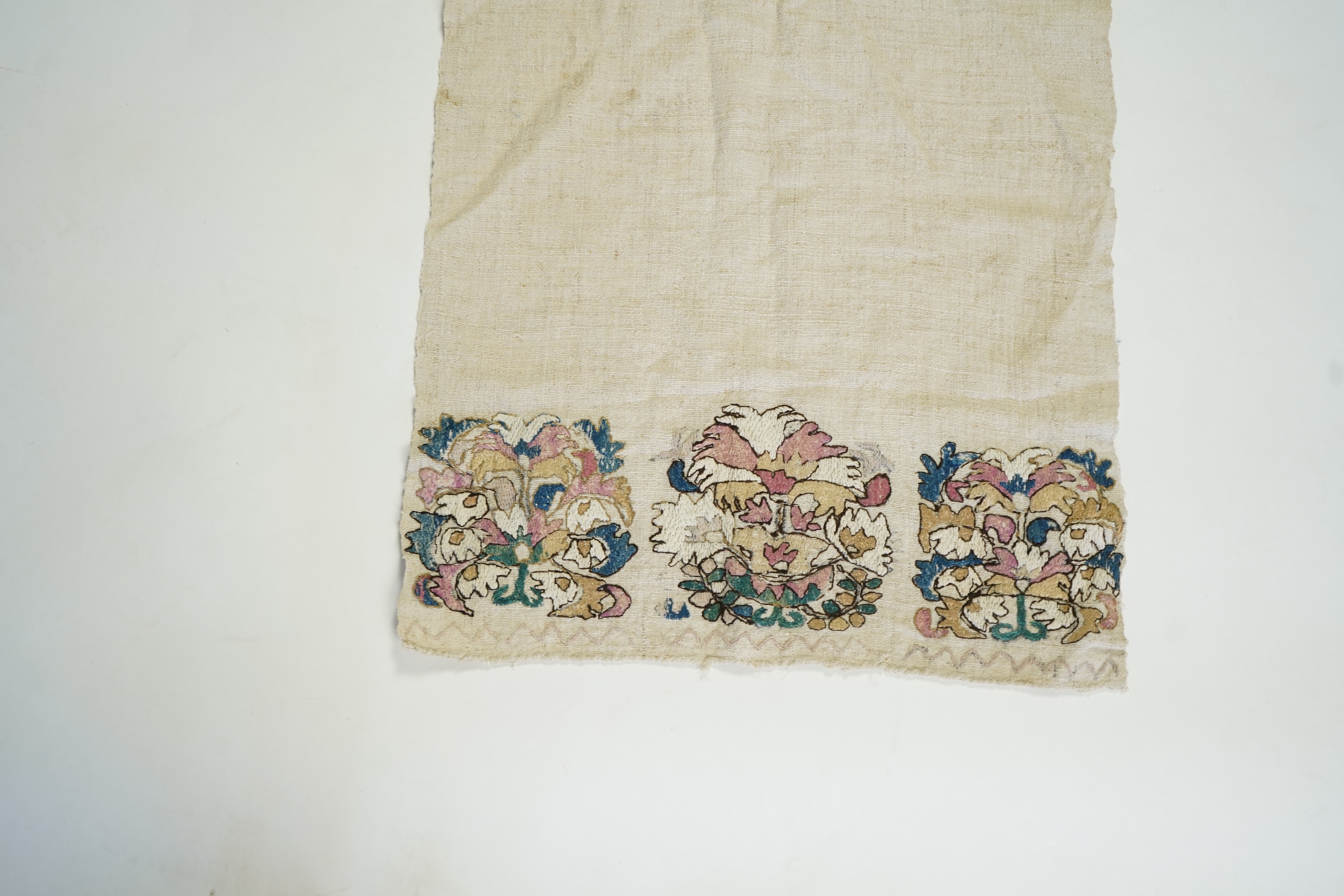 An early 20th century heavy hand woven linen Turkish towel, with coloured silk embroidered ends. 123cm long x 43cm wide. Condition - has two stains and some embroidery worn in places.